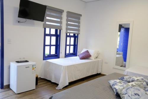 Ένα ή περισσότερα κρεβάτια σε δωμάτιο στο Pequeno Paraíso