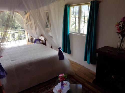 Postel nebo postele na pokoji v ubytování Hosteria Rose Cottage