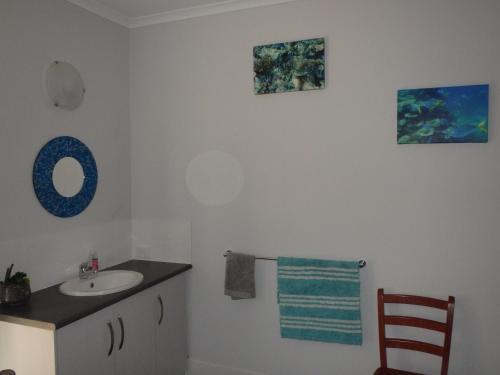 a bathroom with a sink and a mirror at Gilligan's Kangaroo Island in Baudin Beach