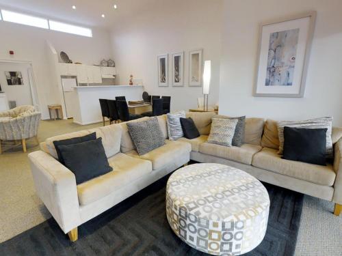 a living room with two couches and a table at Lodge Apartment 20 The Stables Perisher in Perisher Valley