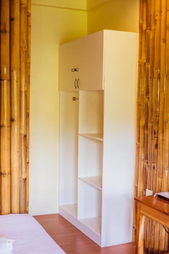 a white refrigerator in the corner of a room at Ceazar's Place in Dauin