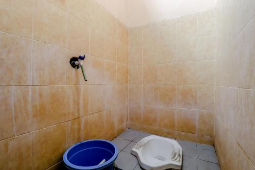 a bathroom with a shower with a toilet in it at Griya Barokah in Kalasan