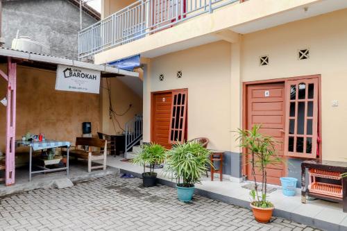 a restaurant with plants in front of a building at Griya Barokah in Kalasan