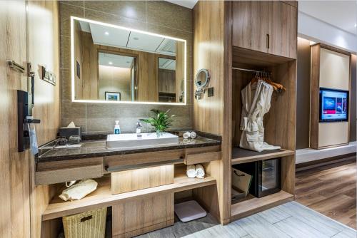 a bathroom with a sink and a large mirror at Atour Hotel Hangzhou West Lake in Hangzhou