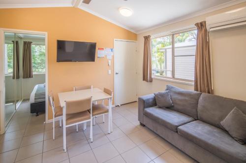 a living room with a couch and a table at Ingenia Holidays Lake Macquarie in Mannering Park