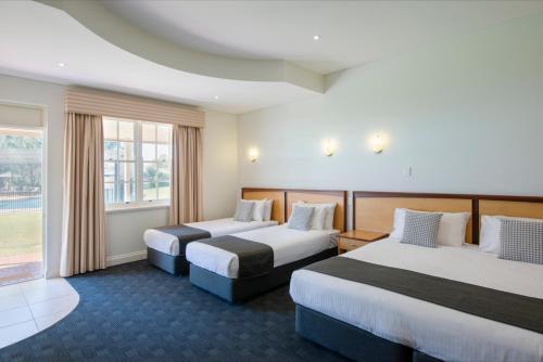 a hotel room with two beds and a window at Serafino McLaren Vale in McLaren Vale