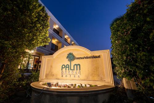 a sign for a palma garden hotel in front of a building at The Palm Garden Hotel in Chiang Rai