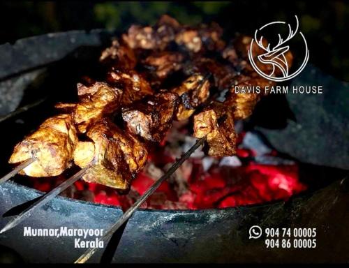 a bunch of food is cooking on a grill at Davis Farm House in Maraiyūr