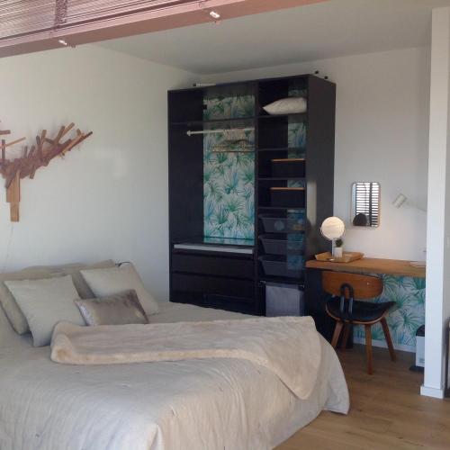 a bedroom with a bed and a desk in it at 22ndFloor Luxury Suite in Ostend