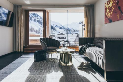 a living room with a couch and a table at The Crystal VAYA Unique in Obergurgl