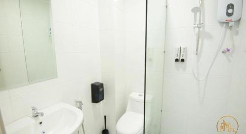 a bathroom with a shower and a toilet and a sink at The Wave Residence Melaka in Melaka