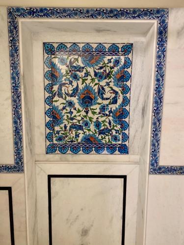 a door with a blue and white tile on it at Jaipur Haveli in Jaipur