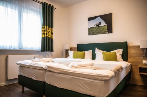 Postel nebo postele na pokoji v ubytování Heide-Trail Dolle