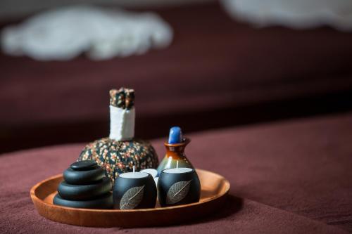 a small tray with a vase and other items on a table at Hanoi Dalvostro Valentino Hotel & Spa in Hanoi