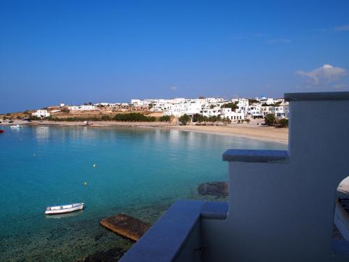 a view of a beach with a boat in the water at To Kima in Koufonisia