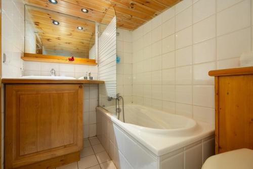 La salle de bains est pourvue d'une baignoire et d'un lavabo. dans l'établissement Résidence Le Cristal - Lognan 8 - Happy Rentals, à Chamonix-Mont-Blanc