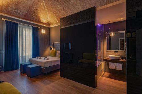 a hotel room with a bed and a bathroom at Palco Rooms&Suites in Palermo