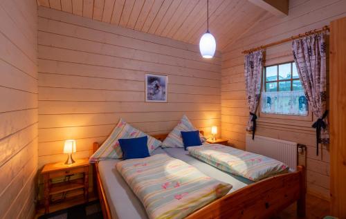 a bedroom with a bed with two pillows and a window at Ferienhaus Vogelsang in Bad Sooden-Allendorf in Bad Sooden-Allendorf