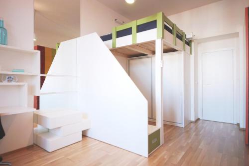a room with a bunk bed in a room at Modern Futuristic Apartment / Žižkov TV Tower + Metro Station in Prague