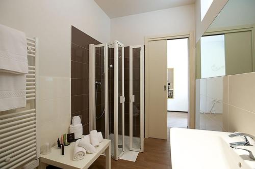 a bathroom with a tub and a sink and a mirror at Hotel Leon D'Oro in Mantova