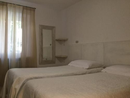 Łóżko lub łóżka w pokoju w obiekcie Albergo Ristorante Leso
