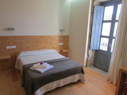 a bedroom with a bed with a towel on it at Posada Real El Brasilero in Saucelle