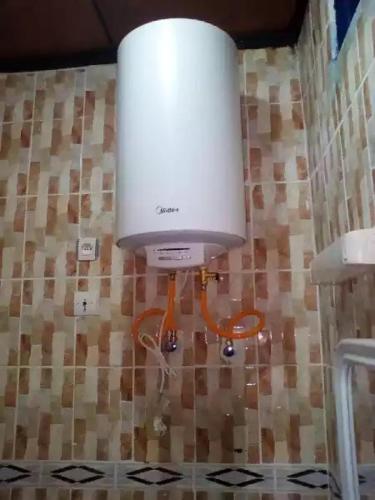 a large white light on the wall of a bathroom at HAKABA in Conakry
