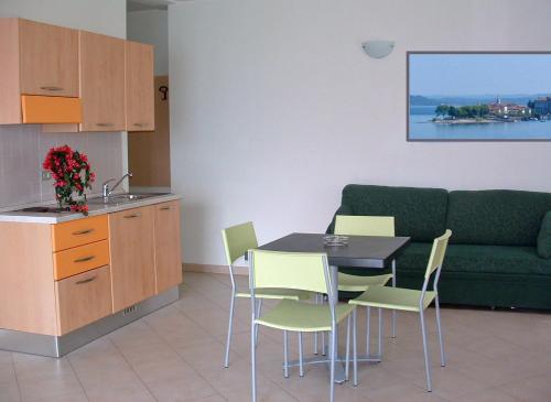 a kitchen with a table and chairs and a couch at Tre ponti monolocale in Verbania