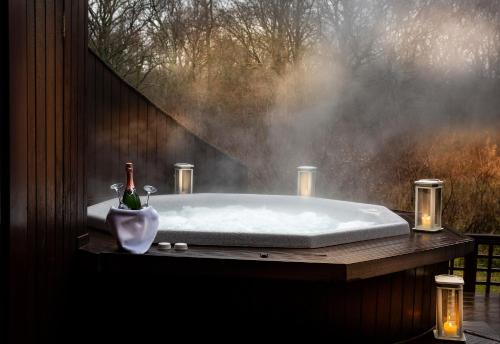 a bath tub with a bottle of wine in it at Solent Hotel and Spa in Fareham