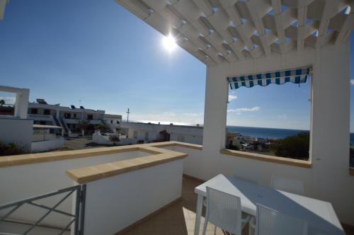 a balcony with a view of the ocean at Holiday Apartments Azzurro Salento in Torre Vado