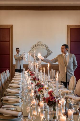 two men standing in front of a long table with candles at The Oberoi Marrakech in Marrakech