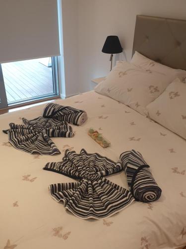 a bed with zebra blankets on top of it at Ocean Village apartment in Gibraltar