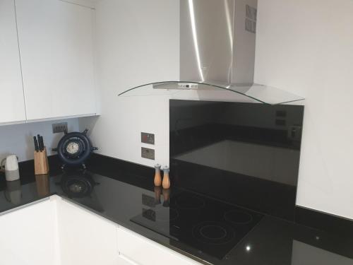 a kitchen with a black and white stove top oven at Ocean Village apartment in Gibraltar