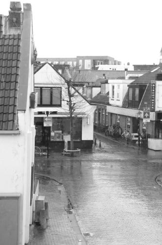 a city street in the rain with buildings at Appartement Lefferts in Zandvoort