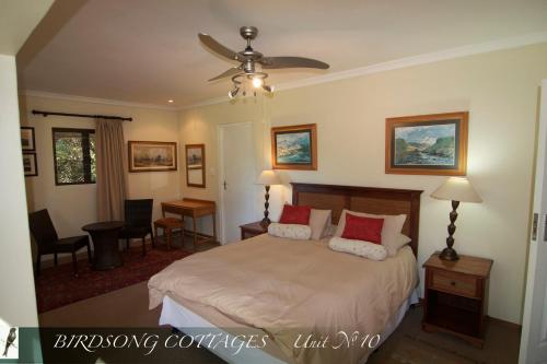 a bedroom with a bed and a living room at Birdsong Cottages - 10 Poplar Drive - Bergview Estate in Champagne Valley