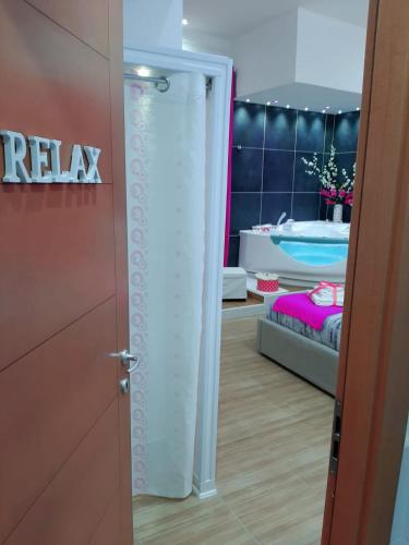 a bathroom with a shower in a room with a bed at Red House in Naples