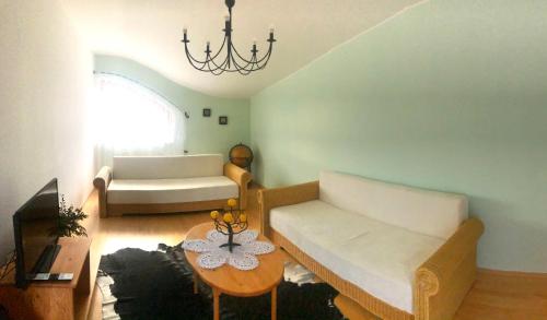 a living room with a couch and a table at Dům U Slunce a Vína in Olbramovice