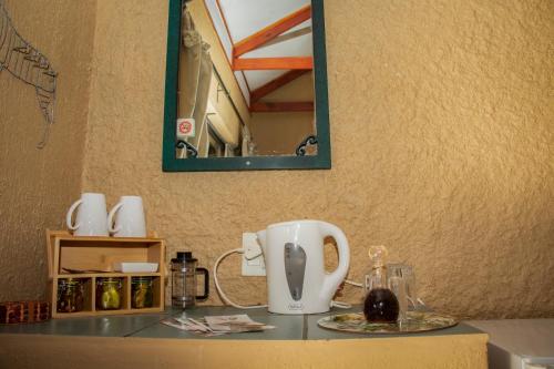 a coffee maker on a counter with a mirror at Elephant's Nest in Graskop