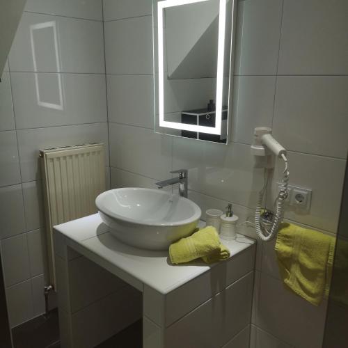 a bathroom with a white sink and a mirror at MaHome Apartments in Lofer