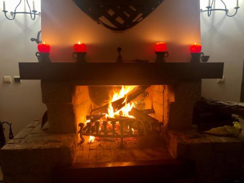 a fireplace with red candles on top of it at Dům U Slunce a Vína in Olbramovice
