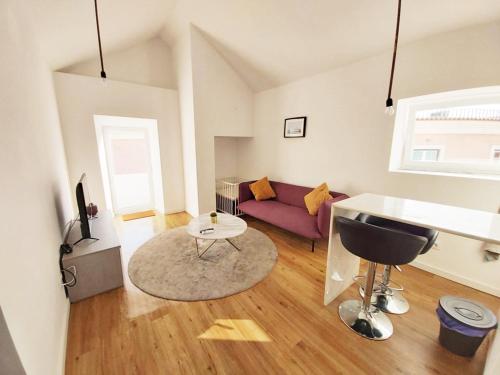 a living room with a couch and a table at Miradouro's Loft in Setúbal