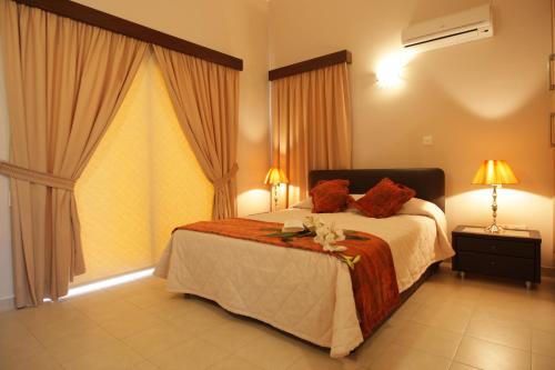 a bedroom with a large bed and a large window at Holidays Villas in Pissouri