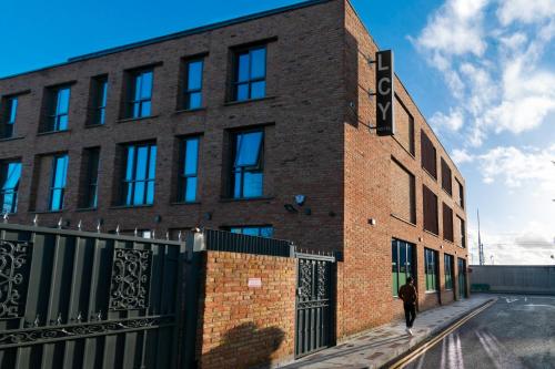 a brick building with a person walking past it at London City Airport Hotel in London