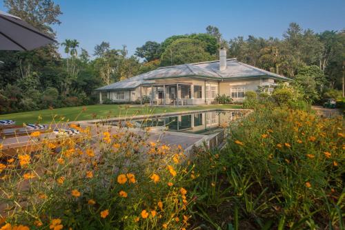 a house with a garden and flowers in front of it at Nine Skies in Ella