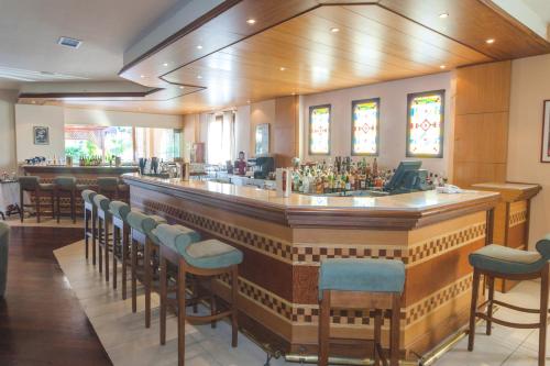 a bar in a restaurant with a lot of chairs at Aegean Melathron Thalasso Spa Hotel in Kallithea Halkidikis