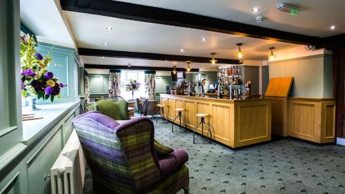 a living room with a bar and a kitchen at The Wyndham Hotel in Clearwell