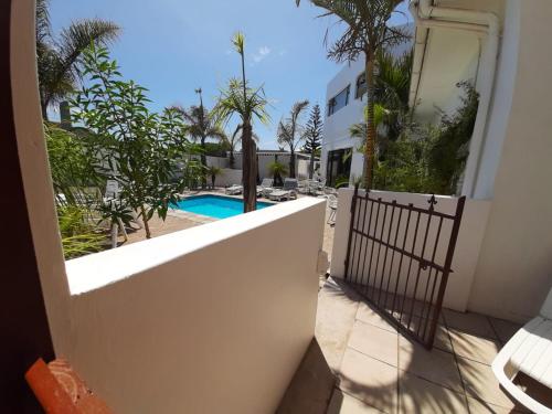a view of a pool from the balcony of a house at Au Plais De Langebaan at Palm Tree Villa in Langebaan
