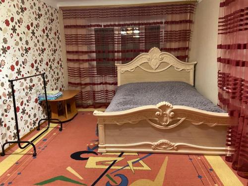 a bedroom with a bed and a window at Михайлівська квартира in Zhytomyr