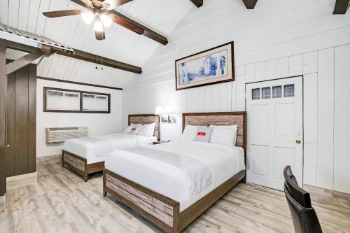 a bedroom with two beds and a ceiling fan at Arrowhead Tree Top Lodge in Lake Arrowhead