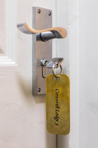 a key tag hanging from a door handle at The Wyndham Hotel in Clearwell